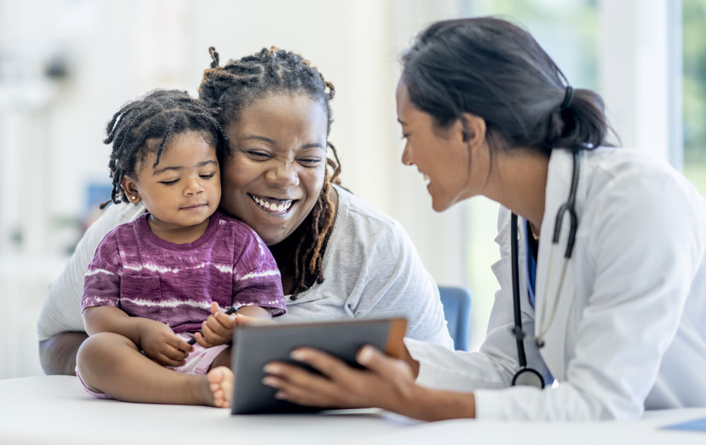 A young mother and her son visit the doctor together.